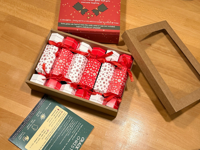 Opened cardboard box with 6 crackers inside on a table